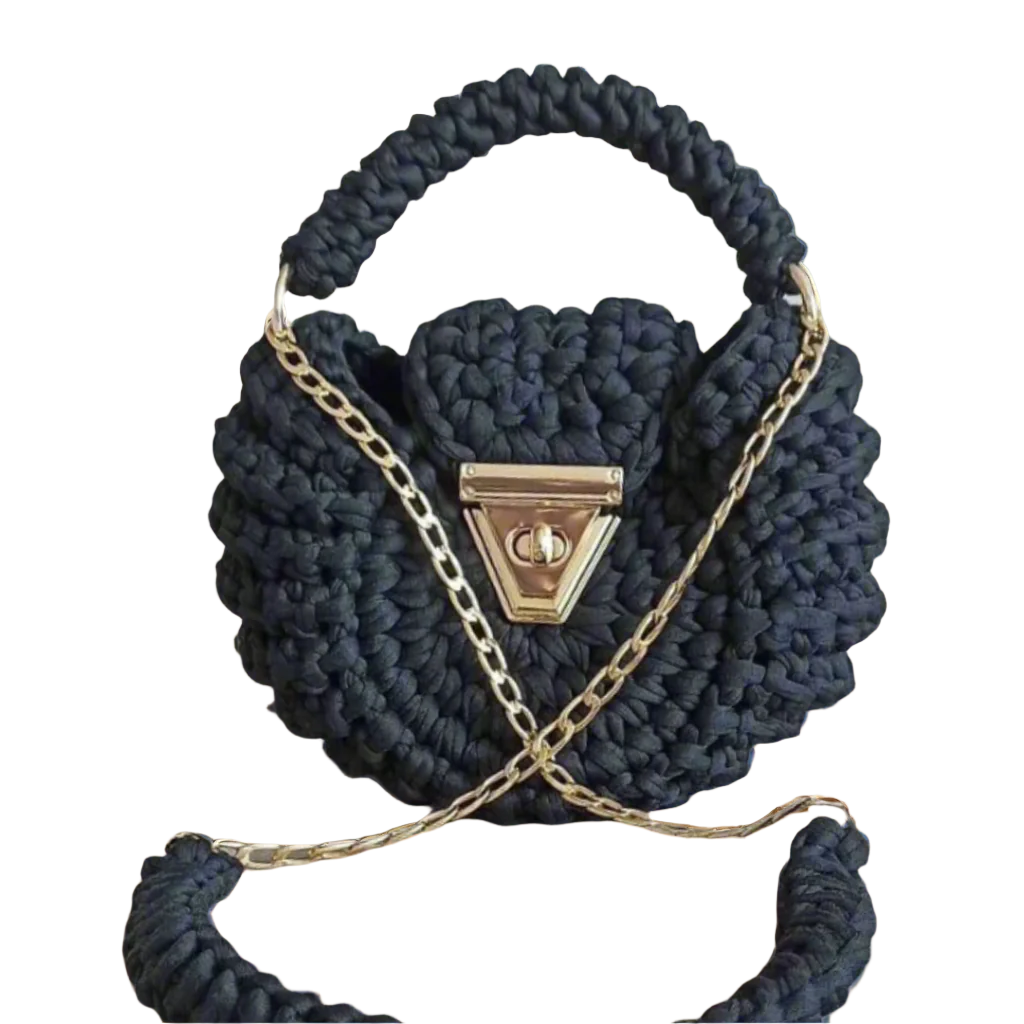 Black round crochet handbag with gold twist-lock clasp, side tassel, and optional gold chain – handcrafted for the Brunch at Tiffany’s Pebble Collection.